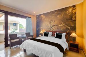 a bedroom with a large bed with a wall mural at Townhouse Oak Su's Cottage Near Legian Beach in Legian +98 photos