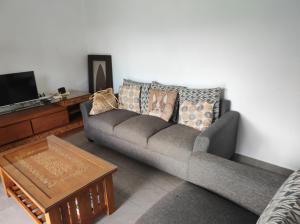 a living room with a couch and a coffee table at mahogany villa in Grand-Baie