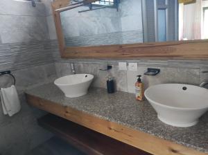 a bathroom with a white sink and a mirror at mahogany villa in Grand-Baie