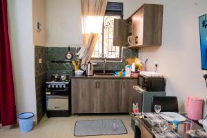 a small kitchen with a sink and a stove at Vine Suites Mbarara Fully Furnished 1BR - Ideal for Short & Long Stays in Mbarara