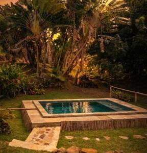 a small swimming pool in a yard with trees at Lambawany in Sainte Marie
