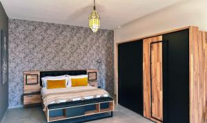 a bedroom with a bed with yellow pillows at Kaha Lak in Douar Aguergour +81 photos