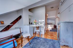 cocina y sala de estar con mesa y escalera en Apartments Selfie Belgrade Central, en Belgrado