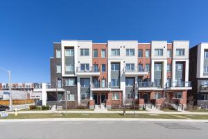 an apartment building on the corner of a street at Downsview Park Luxury Townhome near Yorkdale Transit in Toronto