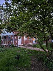 a red brick building with a white garage at Haus Adele in Drochtersen