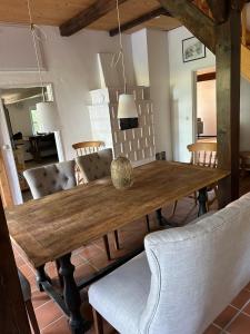 a dining room with a wooden table and chairs at Haus Adele in Drochtersen