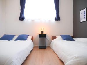 two beds sitting next to each other in a room at MSTAY池袋one in Tokyo +33 photos