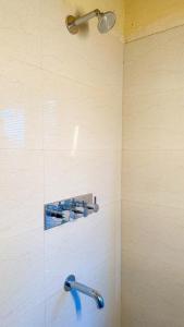 a bathroom with a shower with a shower head at Pillow on the Cloud in Rāmgarh