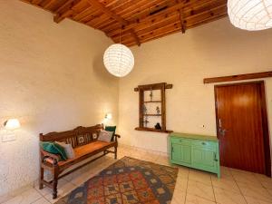a room with a bench and a table and two lights at Bird Songs in Rāmgarh