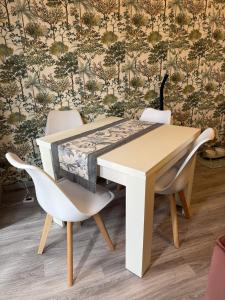a dining table and chairs with a wall at Colombo 49 Guest House in Gallarate