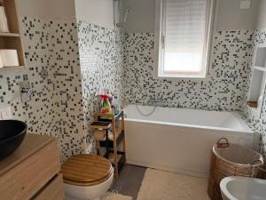 a bathroom with a tub and a toilet and a sink at Colombo 49 Guest House in Gallarate +14 photos