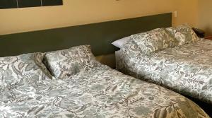 a bed with two pillows on top of it at Retasket Lodge & RV Park in Lillooet