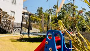a playground with a blue and red slide at Skylark Holidays Chinnakanal in Chinnakanal