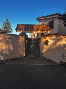 a house with a gate and a fence at Locazione Turistica Antonella in Fiumicino