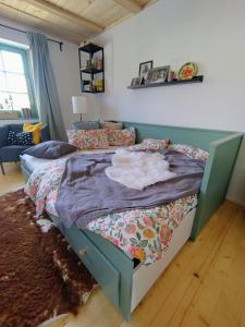 a bedroom with a bed with a blanket on it at Mera Small House in Mera