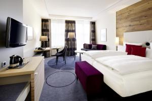 a hotel room with a large bed and a desk at Best Western Premier Park Hotel & Spa in Bad Lippspringe