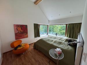 a bedroom with a large bed and a large window at Haus Titschendorf in Wurzbach
