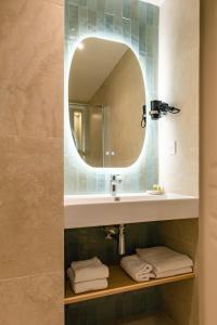 a bathroom with a sink and a mirror at Hôtel Restaurant Le Lachens in La Bastide +83 photos