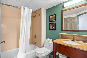 a bathroom with a toilet and a sink and a mirror at Comfort Inn Foxboro - Mansfield in Foxborough +44 photos