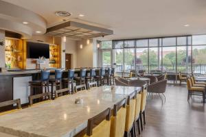 a large dining room with a large table and chairs at Cambria Hotel Denver International Airport in Aurora