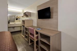 a small hotel room with a desk and a kitchen at Rodeway Inn Ardmore I-65 in Elkton