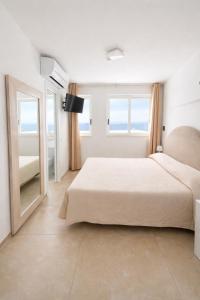 a bedroom with a large bed and a large mirror at B&B Il Paradiso di Capri in Anacapri +35 photos