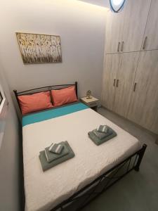 a bedroom with a bed with two towels on it at Luxury Rofos Residence in Elounda