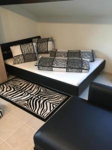 a bed in a room with a zebra print rug at Apartment Lala in Interlaken
