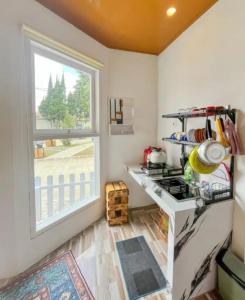 a kitchen with a stove and a window at Teras Candi Villa in Diyeng