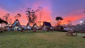 a lodge with a sunset in the background at Artana cabin in Palayangan