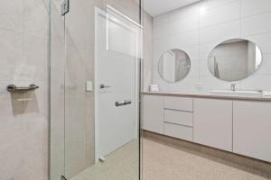 a bathroom with a glass shower and a sink at Riversands Rest Accommodation Scenic Riverfront Cottages, Paringa in Renmark +20 photos