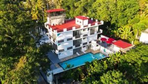 an aerial view of a building with a swimming pool at Hotel Emerald Green in Weligama