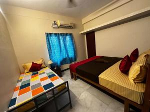 a bedroom with two beds and a window at IP - Malar in Pondicherry