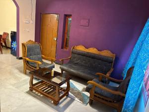 a living room with a couch and two chairs at IP - Malar in Pondicherry