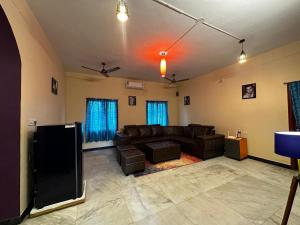a living room with a couch and a tv at IP - Malar in Pondicherry