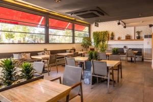 a restaurant with tables and chairs and windows at Pure Blanche Hotel in Antalya