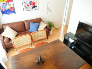 a living room with a couch and a table at MSTAY池袋one in Tokyo