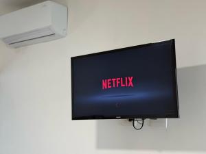 a flat screen tv with the netflix sign on it at Casa DOS21 Boutique Apartments Playa Sur in Mazatlán