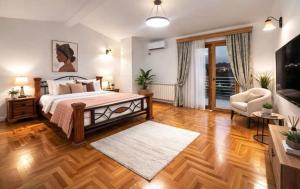 a large bedroom with a bed and a living room at Villa Jakov in Podgorica