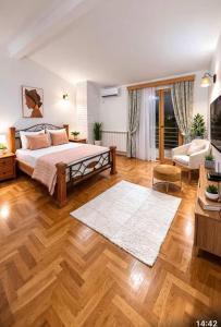 a bedroom with a bed and a living room at Villa Jakov in Podgorica