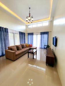 a living room with a couch and a table at Villa Emee Nora in Panglao Island