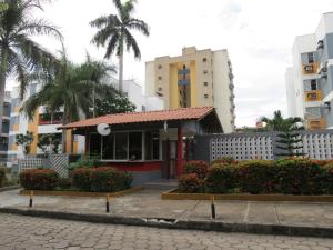 a small building in the middle of some buildings at APART HOTEL MANAUS 10 Pessoas 4 Quartos in Manaus