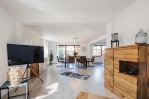 a living room with a large flat screen tv at Gartenidyll in Zingst