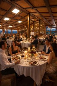 a group of people sitting at tables in a restaurant at POARTA PADINA, statiunea Pestera-Padina, Bucegi in Moroeni