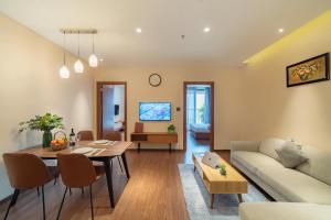 a living room with a couch and a table at DHTS Business Hotel & Apartment in Ho Chi Minh City