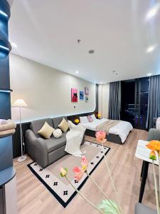 a living room with a couch and a bed at ICON40 Homestay Hạ Long - Ocean View in Ha Long