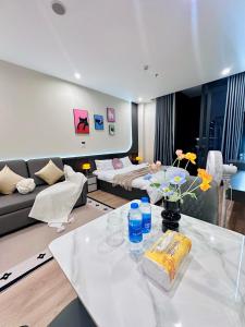 a living room with a couch and a table at ICON40 Homestay Hạ Long - Ocean View in Ha Long