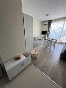a living room with a couch and a table at Seaside Escape Studio in Byala