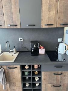 a kitchen with a sink and a counter top with a sink at Seaside Escape Studio in Byala