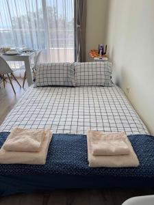 a bed in a room with two pillows on it at Seaside Escape Studio in Byala +14 photos